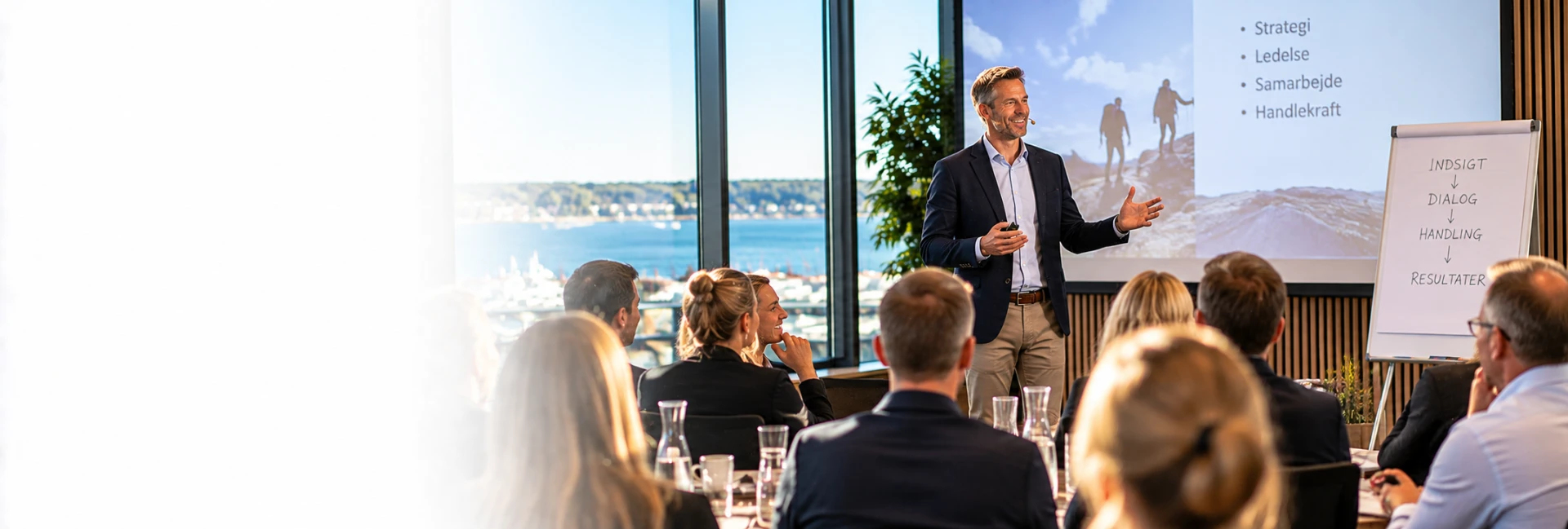 Mads Cronquist giving a talk to a group of managers in a bright meeting room